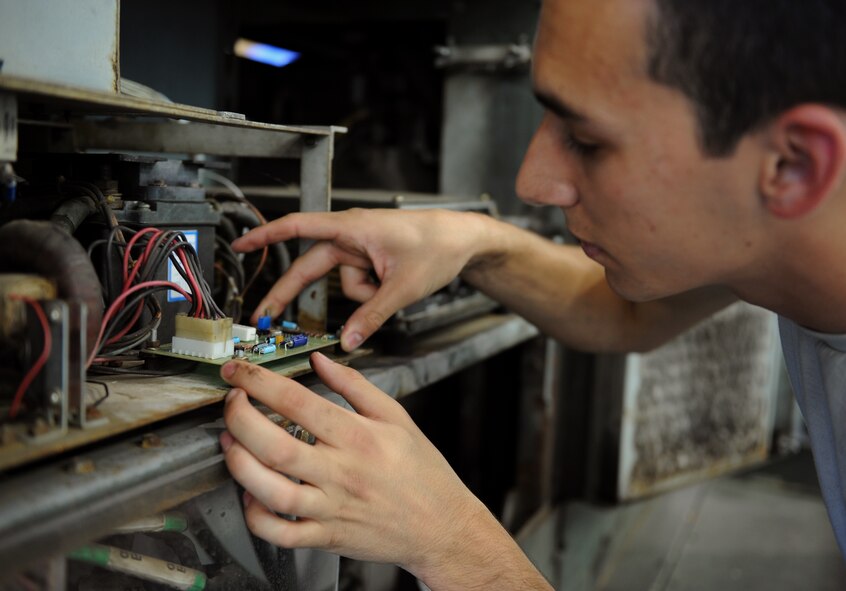 Airman 1st Class Olin Bybee, 2nd Maintenance Squadron Aerospace Ground Equipment flight, checks a circuit board for abnormalities on Barksdale Air Force Base, La., July 8, 2013. The AGE flight is responsible for the equipment maintainers use to keep aircraft mission ready. (U.S. Air Force photo/Airman 1st Class Benjamin Gonsier)