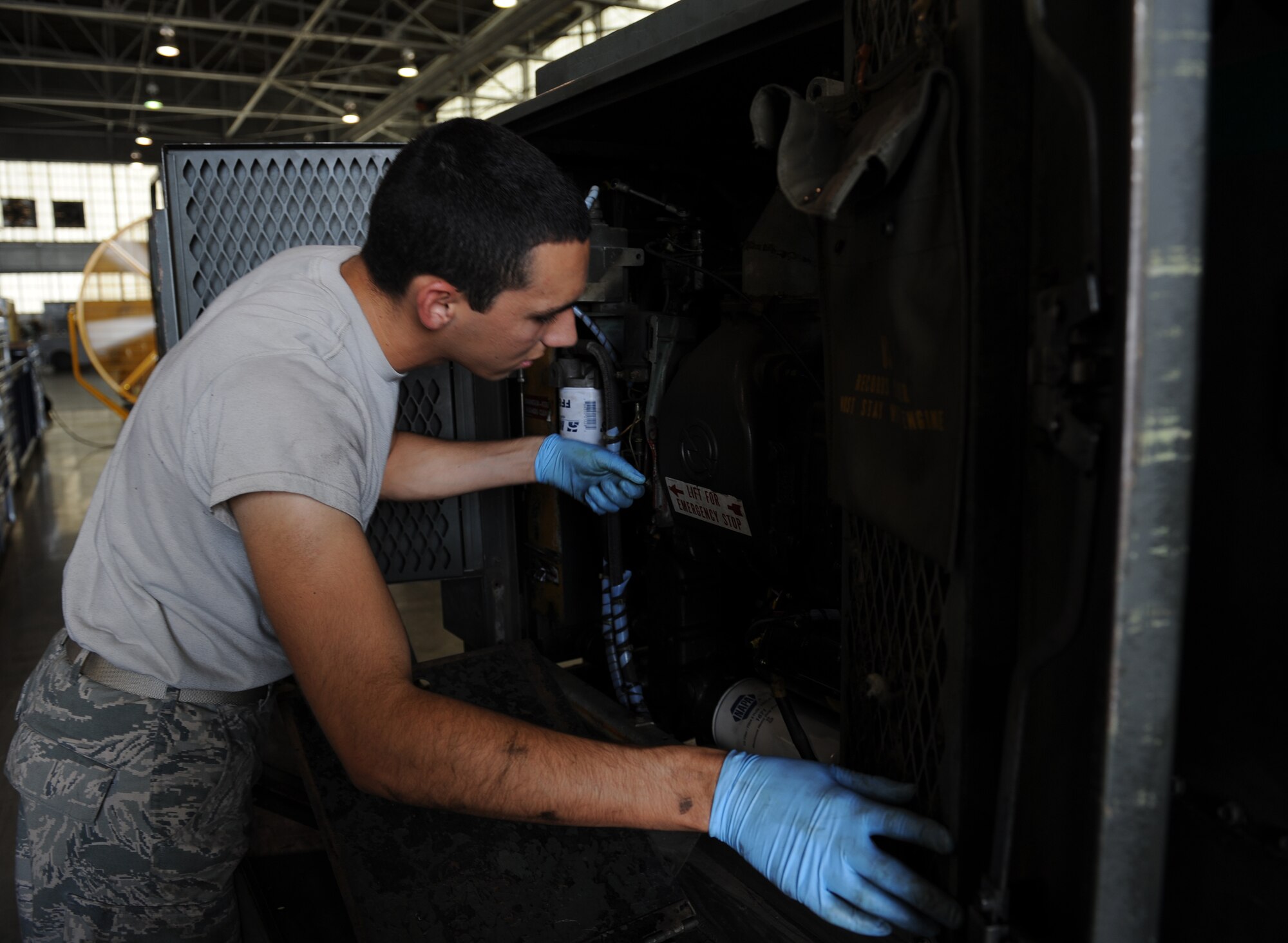 Airman 1st Class Olin Bybee, 2nd Maintenance Squadron Aerospace Ground Equipment flight, inspects a diesel engine generator on Barksdale Air Force Base, La., July 8, 2013. The generator is used to power up aircraft during maintenance. (U.S. Air Force photo/Airman 1st Class Benjamin Gonsier)
