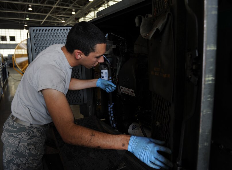 Airman 1st Class Olin Bybee, 2nd Maintenance Squadron Aerospace Ground Equipment flight, inspects a diesel engine generator on Barksdale Air Force Base, La., July 8, 2013. The generator is used to power up aircraft during maintenance. (U.S. Air Force photo/Airman 1st Class Benjamin Gonsier)