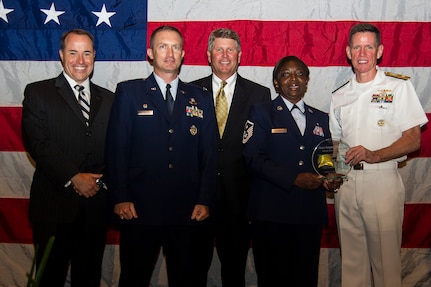 Rear Adm. Richard  Breckenridge (right), Undersea Warfare Division director, and Col. James J. Fontanella, 315th Airlift Wing commander, present Master Sgt. Martha Sass, 317th Airlift Squadron first sergeant , the Enlisted  Reservist of the Year award,  June 27, 2013, during the “Salute the Military” ceremony at the North Charleston Performing Arts Center, North Charleston, S.C. (From left to right) Jon Rudy of General Dynamics Land Systems Force Protection, the Title Sponsor, and Mr. Stuart Whiteside, Charleston Metro Chamber Chairman of the Board, are also pictured here. Sass volunteered more than 250 hours of her time to community service. Sass advises the 317th AS commander on a wide range of topics including fitness, discipline, mentoring, well-being, career progression, professional development, and recognition of all assigned enlisted members. (U.S. Air Force photo/Staff Sgt. Rasheen Douglas)