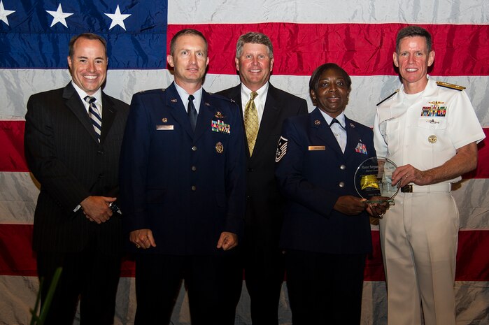 Rear Adm. Richard  Breckenridge (right), Undersea Warfare Division director, and Col. James J. Fontanella, 315th Airlift Wing commander, present Master Sgt. Martha Sass, 317th Airlift Squadron first sergeant , the Enlisted  Reservist of the Year award,  June 27, 2013, during the “Salute the Military” ceremony at the North Charleston Performing Arts Center, North Charleston, S.C. (From left to right) Jon Rudy of General Dynamics Land Systems Force Protection, the Title Sponsor, and Mr. Stuart Whiteside, Charleston Metro Chamber Chairman of the Board, are also pictured here. Sass volunteered more than 250 hours of her time to community service. Sass advises the 317th AS commander on a wide range of topics including fitness, discipline, mentoring, well-being, career progression, professional development, and recognition of all assigned enlisted members. (U.S. Air Force photo/Staff Sgt. Rasheen Douglas)