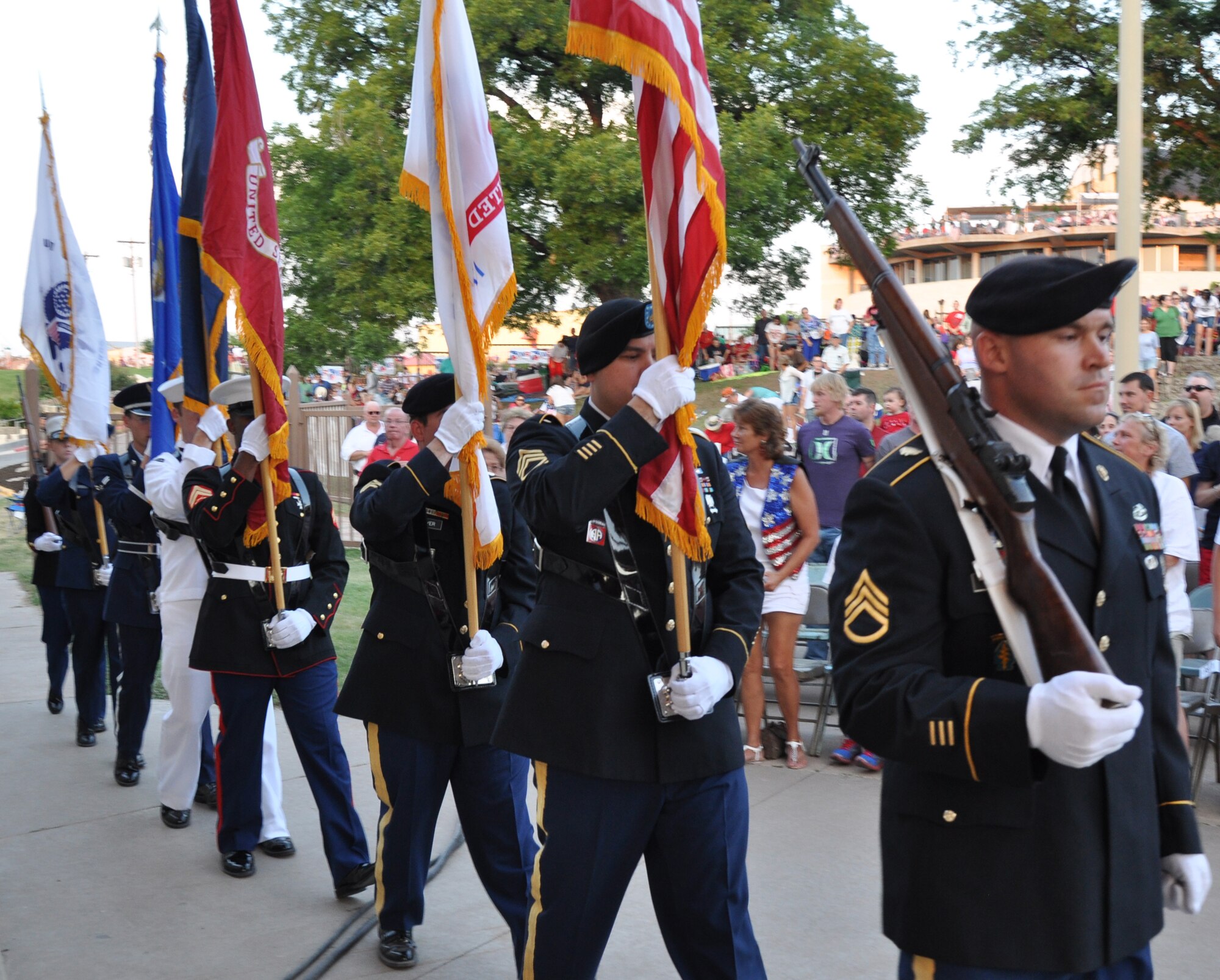SAN ANGELO, Texas – The Goodfellow Joint Service Color Guard marches to the center of the Bill Aylor Sr. Memorial River Stage for the national anthem during the annual July 3rd Pops Concert. Also while the Color Guard presented the colors, 50 service members carried the state flags of all 50 states to the sides of the River Stage. (U.S. Air Force photo/ Airman 1st Class Joshua Edwards)