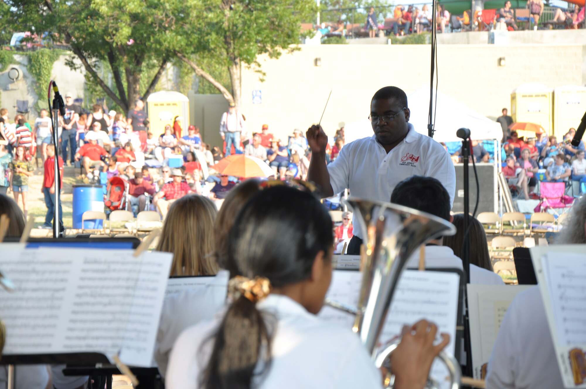 SAN ANGELO, Texas – Daniel McCloud, San Angelo Community Band director, conducts the community band as they play for the annual July 3rd Pops Concert at the Bill Aylor Sr. Memorial River Stage . The community band was the opening act for the San Angelo Symphony and firework show. (U.S. Air Force photo/ Airman 1st Class Joshua Edwards)