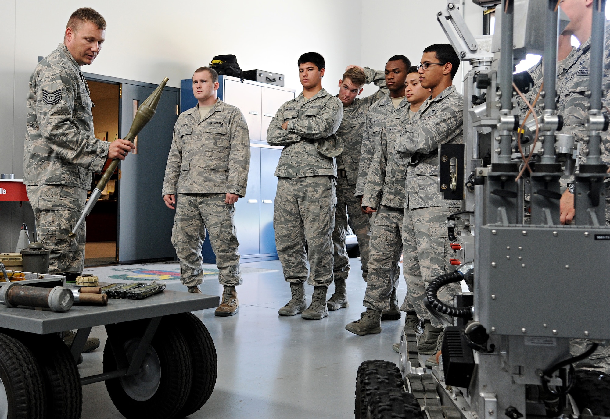 Tech. Sgt. Lenny Eckstein, 375th Civil Engineer Squadron explosive ordnance disposal technician, shows the different types of explosives that EOD technicians handle during a visit from the United States Air Force Academy cadets July 8 at Scott Air Force Base, Ill. The cadets learned about the vigorous training that EOD technicians must go through to become specialists and also got to test their strength by lifting heavy equipment while wearing an 80-pound bomb suit. (U.S. Air Force photo/Airman 1st Class Kristina Forst)