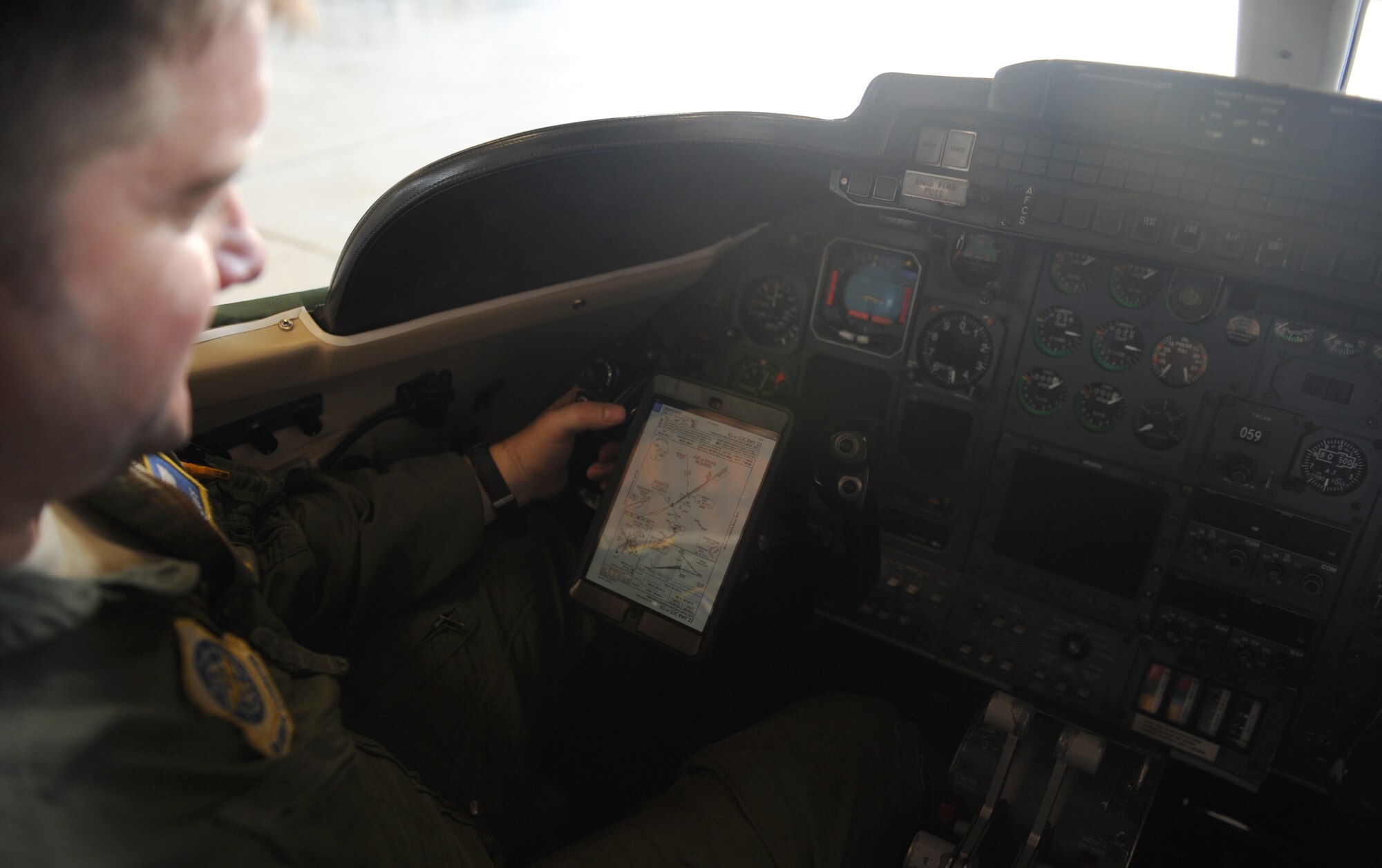 Maj. Jared Detloff,  375th Operations Group standardization evaluation chief, looks at the iPad mini June 30 he uses as his electronic flight bag when he flies the C-21A.  Scott Air Force Base has been selected as a test base for this project, which will reduce paper waste and fuel costs.  The electronic tablet replaces 40-50 pounds of paper-based reference material. (U.S. Air Force photo/Senior Airman Divine Cox)
