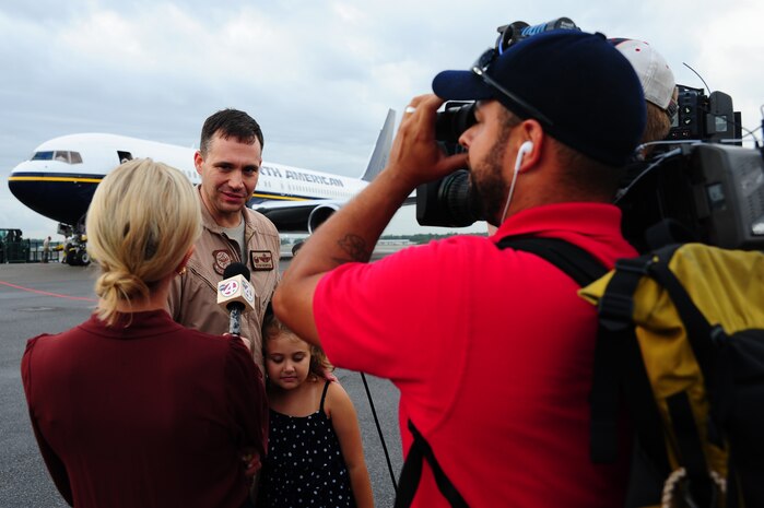 Lt. Col. Stewart Newton, 16th Airlift Squadron commander, answers a reporter’s questions during an during the 437th Airlift Wing’s 16th AS redeployment July 2, 2013, at Joint Base Charleston - Air Base, S.C. More than 120 Airmen from the 16th AS returned home from a 60-day deployment to Southwest Asia. Flying the C-17 Globemaster III, crews flew and supported roughly 1,000 sorties, logged more than 2,500 combat flying hours and airlifted more than 36 million pounds of cargo. (U.S. Air Force photo/ Airman 1st Class Chacarra Neal)