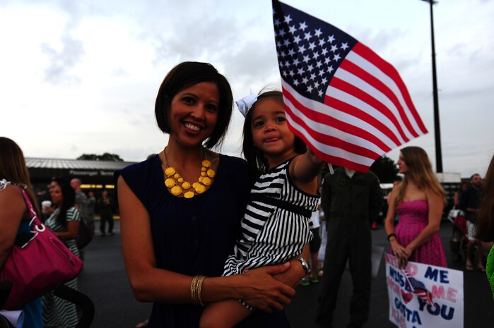 Katrina Denny  and her 2-year old daughter Reese, awaits Tech. Sgt. Josh Denny’s arrivalduring the 437th Airlift Wing’s 16th AS redeployment July 2, 2013, at Joint Base Charleston - Air Base, S.C. More than 120 Airmen from the 16th AS returned home from a 60-day deployment to Southwest Asia. Flying the C-17 Globemaster III, crews flew and supported roughly 1,000 sorties, logged more than 2,500 combat flying hours and airlifted more than 36 million pounds of cargo. (U.S. Air Force photo/ Airman 1st Class Chacarra Neal)