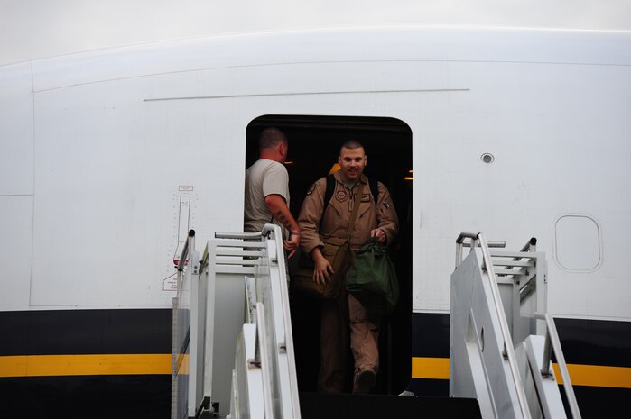 Senior Airman Michael Denk,  16th Airlift Squadron loadmaster,  was the first returning member of the 16th AS to exit the commercial plane which flew them home during the 437th Airlift Wing’s 16th AS redeployment July 2, 2013, at Joint Base Charleston - Air Base, S.C. More than 120 Airmen from the 16th AS returned home from a 60-day deployment to Southwest Asia. Flying the C-17 Globemaster III, crews flew and supported roughly 1,000 sorties, logged more than 2,500 combat flying hours and airlifted more than 36 million pounds of cargo. (U.S. Air Force photo/ Airman 1st Class Chacarra Neal)