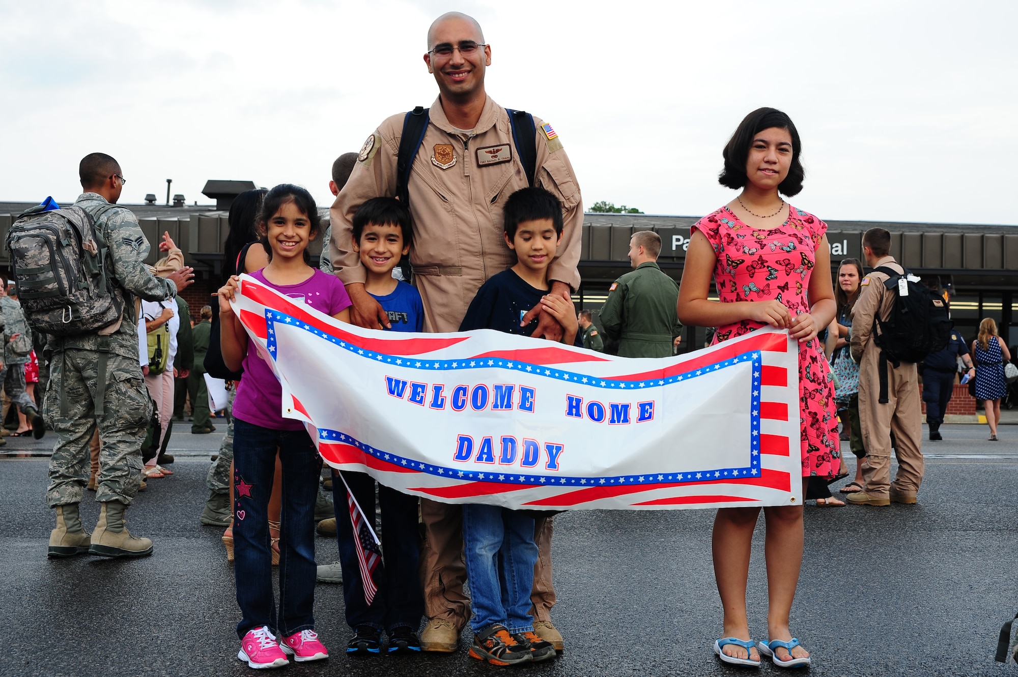 Tech. Sgt. Rafael Chapa, 16th Airlift Squadron loadmaster, is welcomed home by his children  during the 16th AS redeployment July 2, 2013, at Joint Base Charleston - Air Base, S.C. More than 120 Airmen from the 16th AS returned home from a 60-day deployment to Southwest Asia. Flying the C-17 Globemaster III, crews flew and supported roughly 1,000 sorties, logged more than 2,500 combat flying hours and airlifted more than 36 million pounds of cargo. (U.S. Air Force photo/ Airman 1st Class Chacarra Neal)