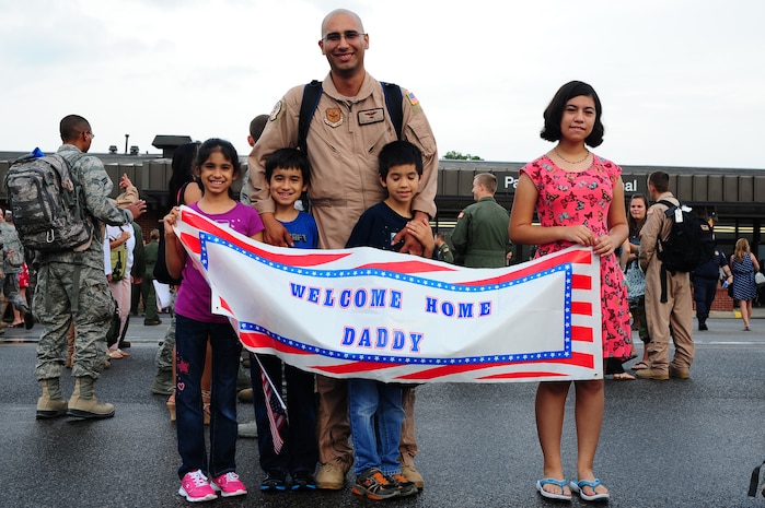 Tech. Sgt. Rafael Chapa, 16th Airlift Squadron loadmaster, is welcomed home by his children  during the 16th AS redeployment July 2, 2013, at Joint Base Charleston - Air Base, S.C. More than 120 Airmen from the 16th AS returned home from a 60-day deployment to Southwest Asia. Flying the C-17 Globemaster III, crews flew and supported roughly 1,000 sorties, logged more than 2,500 combat flying hours and airlifted more than 36 million pounds of cargo. (U.S. Air Force photo/ Airman 1st Class Chacarra Neal)