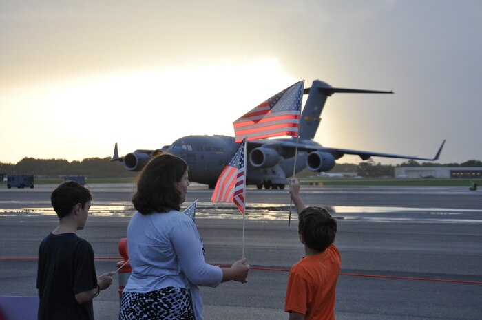 Family members await the arrival of the 437th Airlift Wing’s 16th Airlift Squadron July 2, 2013, at Joint Base Charleston - Air Base, S.C. More than 120 Airmen from the 16th AS returned home from a 60-day deployment to Southwest Asia. Flying the C-17 Globemaster III, crews flew and supported roughly 1,000 sorties, logged more than 2,500 combat flying hours and airlifted more than 36 million pounds of cargo. (U.S. Air Force photo/ Capt. Francis Hartnett)