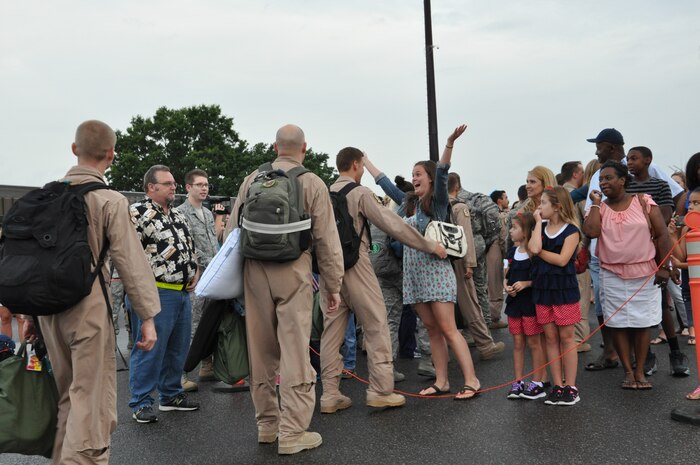 Returning members of the 437th Airlift Wing’s 16th Airlift Squadron greet their family members during the 16th AS redeployment July 2, 2013, at Joint Base Charleston - Air Base, S.C. More than 120 Airmen from the 16th AS returned home from a 60-day deployment to Southwest Asia. Flying the C-17 Globemaster III, crews flew and supported roughly 1,000 sorties, logged more than 2,500 combat flying hours and airlifted more than 36 million pounds of cargo. (U.S. Air Force photo/ Capt. Francis Hartnett)