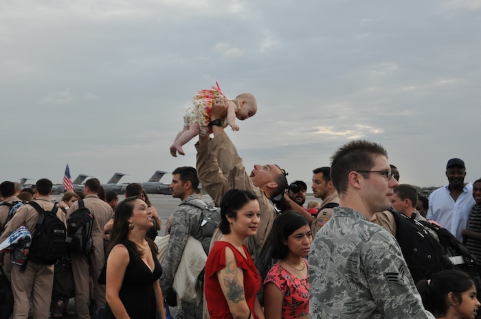 Returning members of the 437th Airlift Wing’s  16th Airlift Squadron greet their family members during the 16th AS redeployment July 2, 2013, at Joint Base Charleston - Air Base, S.C. More than 120 Airmen from the 16th AS returned home from a 60-day deployment to Southwest Asia. Flying the C-17 Globemaster III, crews flew and supported roughly 1,000 sorties, logged more than 2,500 combat flying hours and airlifted more than 36 million pounds of cargo. (U.S. Air Force photo/ Capt. Francis Hartnett)