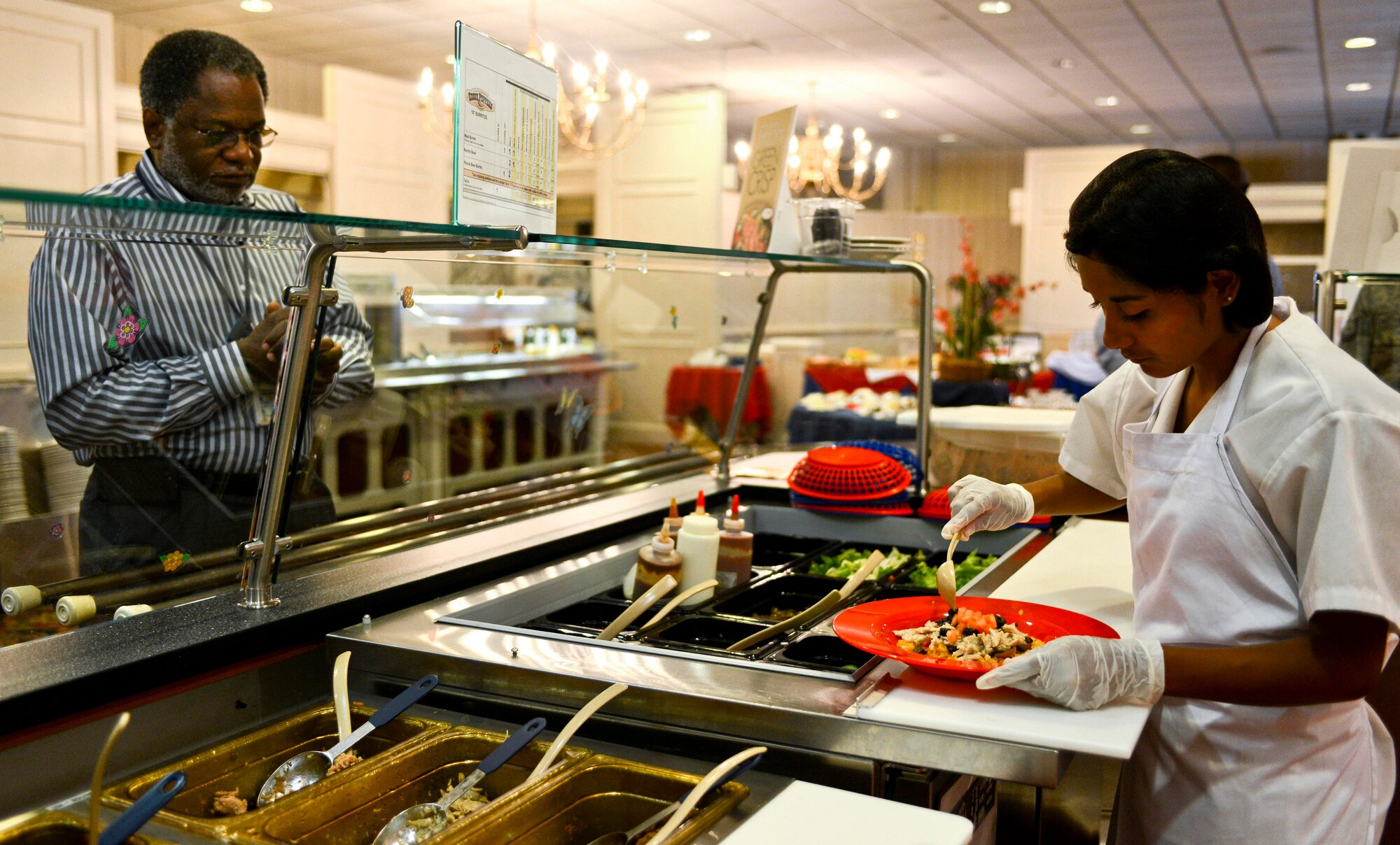 Vianey Hernandez, Langley Club cook, prepares lunch for a customer at Langley Air Force Base, Va., July 9, 2013. Since it first opened its doors in May 2011, the club has hosted more than 1,200 special functions spanning from retirement ceremonies, squadron parties and promotions to non-military events such as weddings, anniversaries, birthdays and private holiday parties. (U.S. Air Force photo by R. Alex Durbin/Released)