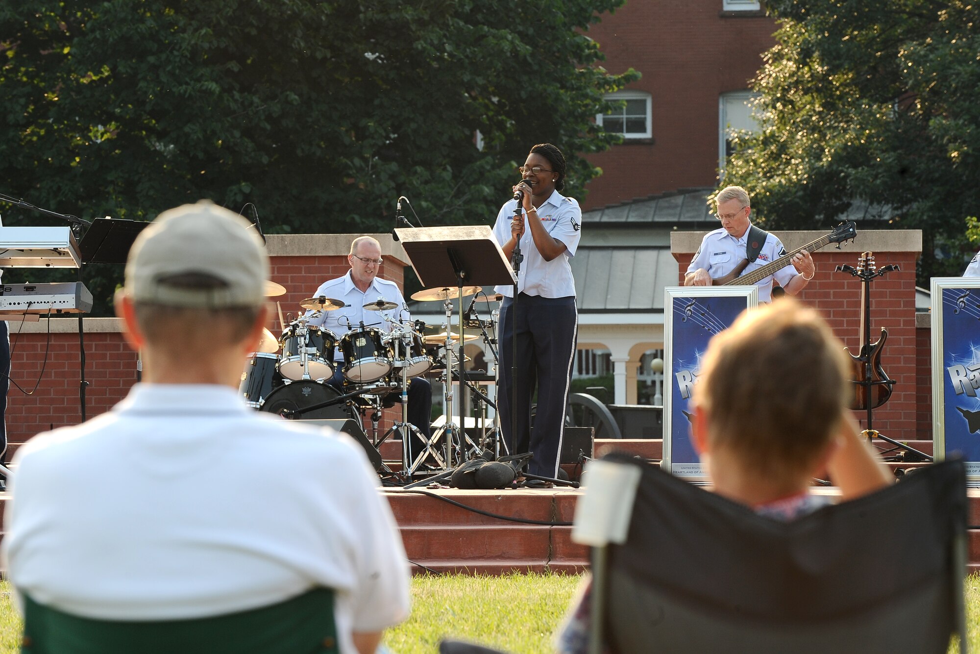 U.S. Air Force Airman 1st Class Paula Hunt, a vocalist with the United States Air Force Heartland of America Band’s Raptor ensemble, sings during the Sundays on Parade concert held on the Parade Grounds on June 30,  Offutt Air Force Base, Neb. More than a hundred people gathered at the parade grounds to listen to Raptor perform. (U.S. Air Force photo by Josh Plueger/Released)