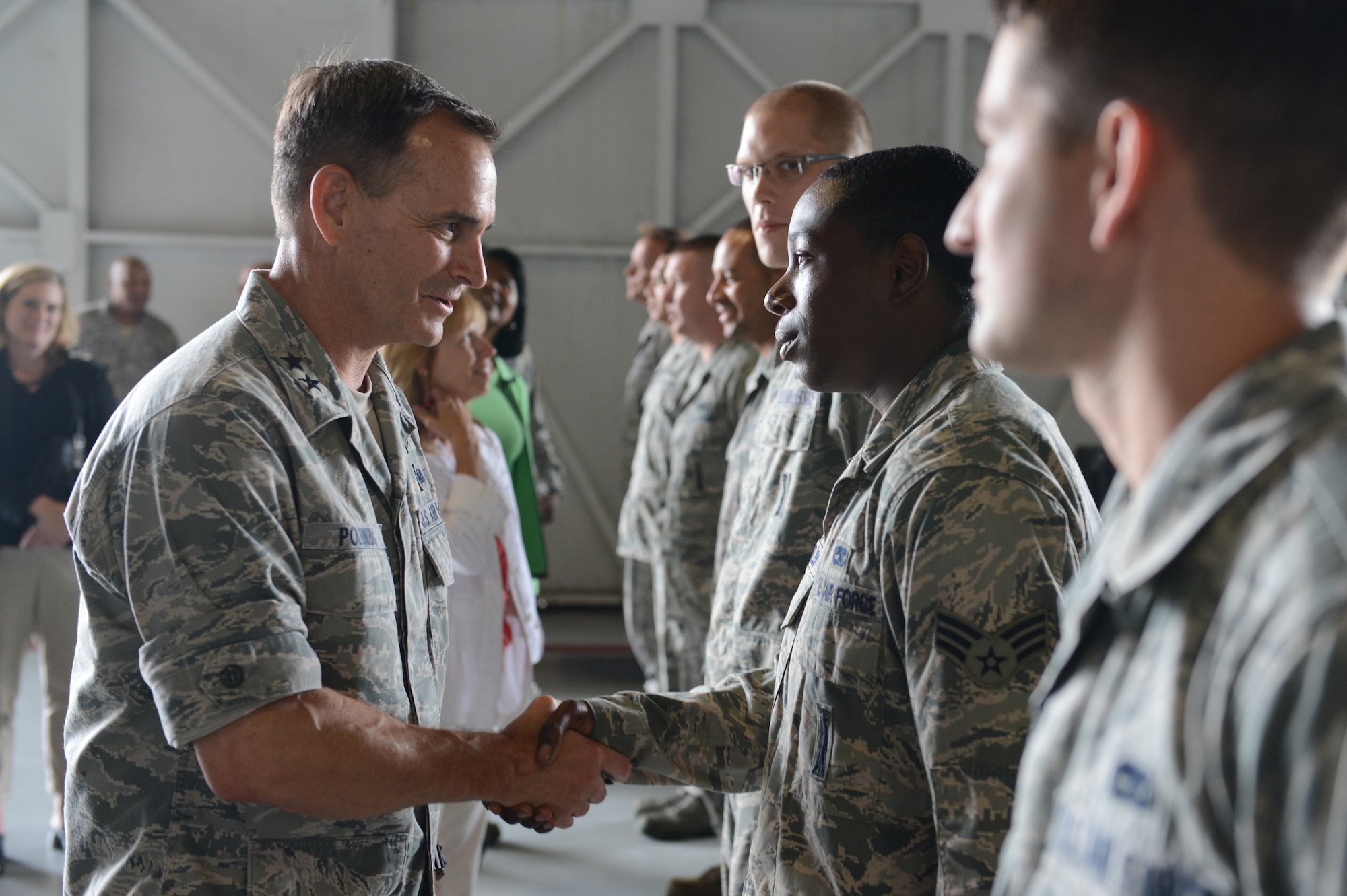 Maj. Gen. Jake Polumbo, 9th Air Force commander, shakes hands and speaks to members of the 20th Maintenance Group at the weapons and standardization facility during a tour of 20th Fighter Wing at Shaw Air Force Base, S.C., July 1, 2013. During the tour, Polumbo also visited other facilities like the McElveen Resource Center, the base dorms and the Chief Master Sgt. Emerson Williams Dining Facility. (U.S. Air Force photo by Airman 1st Class Krystal M. Jeffers/Released)