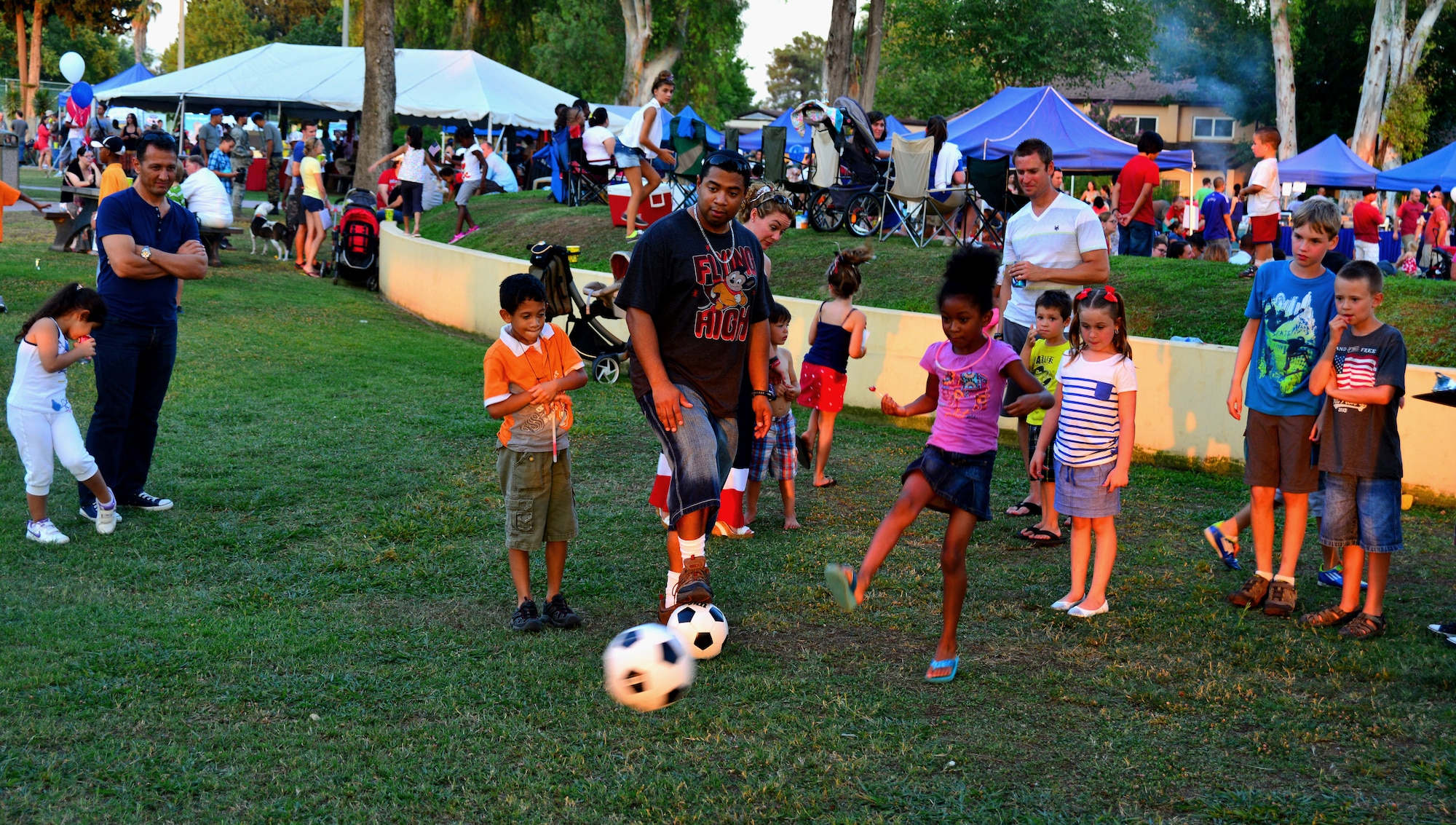 A dependent tries to kick a soccer ball into a  goal during the soccer challenge July 4, 2013, at Incirlik Air Base, Turkey.  The soccer challenge was one of several events hosted by the 39th Force Support Squadron during the Fourth of July celebration at Incirlik AB. (U.S. Air Force photo by Staff Sgt. Eric Summers Jr./Released)