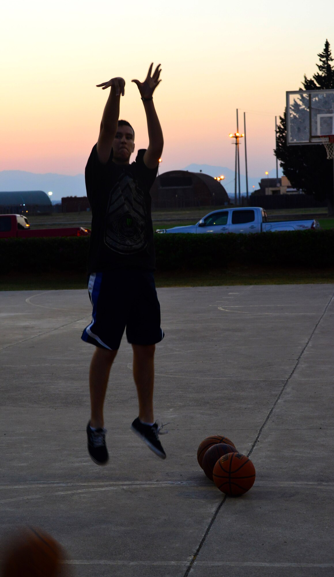 A contestant in the three-point shoot-out attempts a shoot July 4, 2013, during the Fourth of July celebration at Incirlik Air Base, Turkey. The three-point shoot-out, water balloon toss and home run derby were several of the events hosted by the 39th Force Support Squadron during the Fourth of July celebration at Incirlik AB. (U.S. Air Force photo by Staff Sgt. Eric Summers Jr./Released)
