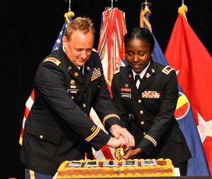 (From left) U.S. Army Chief Warrant Officer Timothy Turner, 7th Sustainment Brigade chief maritime operations officer, and Warrant Officer Cy'Tique Johnson, 7th Sustainment Brigade adjutant general technician, cut the warrant officer birthday cake during the U.S. Army warrant officer corps' 95th birthday celebration inside Jacobs Theater at Fort Eustis, Va., July 9, 2013. The U.S. Army warrant officer corps was created July 9, 1918. (U.S. Air Force photo by Staff Sgt. Wesley Farnsworth/Released) 
