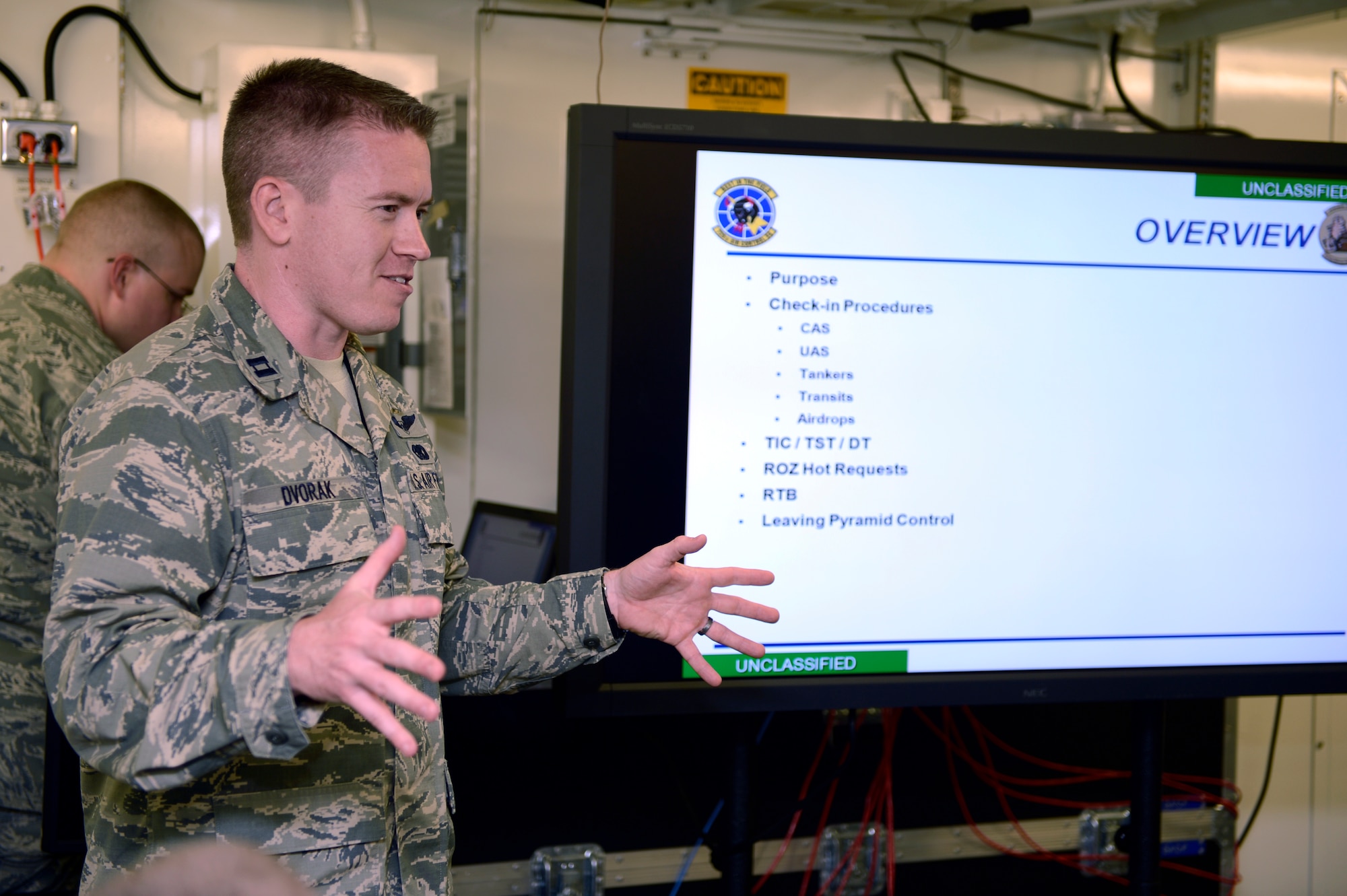 U.S. Air Force Capt. Brad Dvorak, 606th Air Control Squadron chief of squadron weapons and tactics from Ceder Rapids, Iowa, leads a presentation to deploying Airmen on command and control employment supporting Operation Enduring Freedom July 1, 2013. The 606th ACS has been training for several months preparing for a deployment to Afghanistan. (U.S. Air Force photo by Staff Sgt. Christopher Ruano/Released)