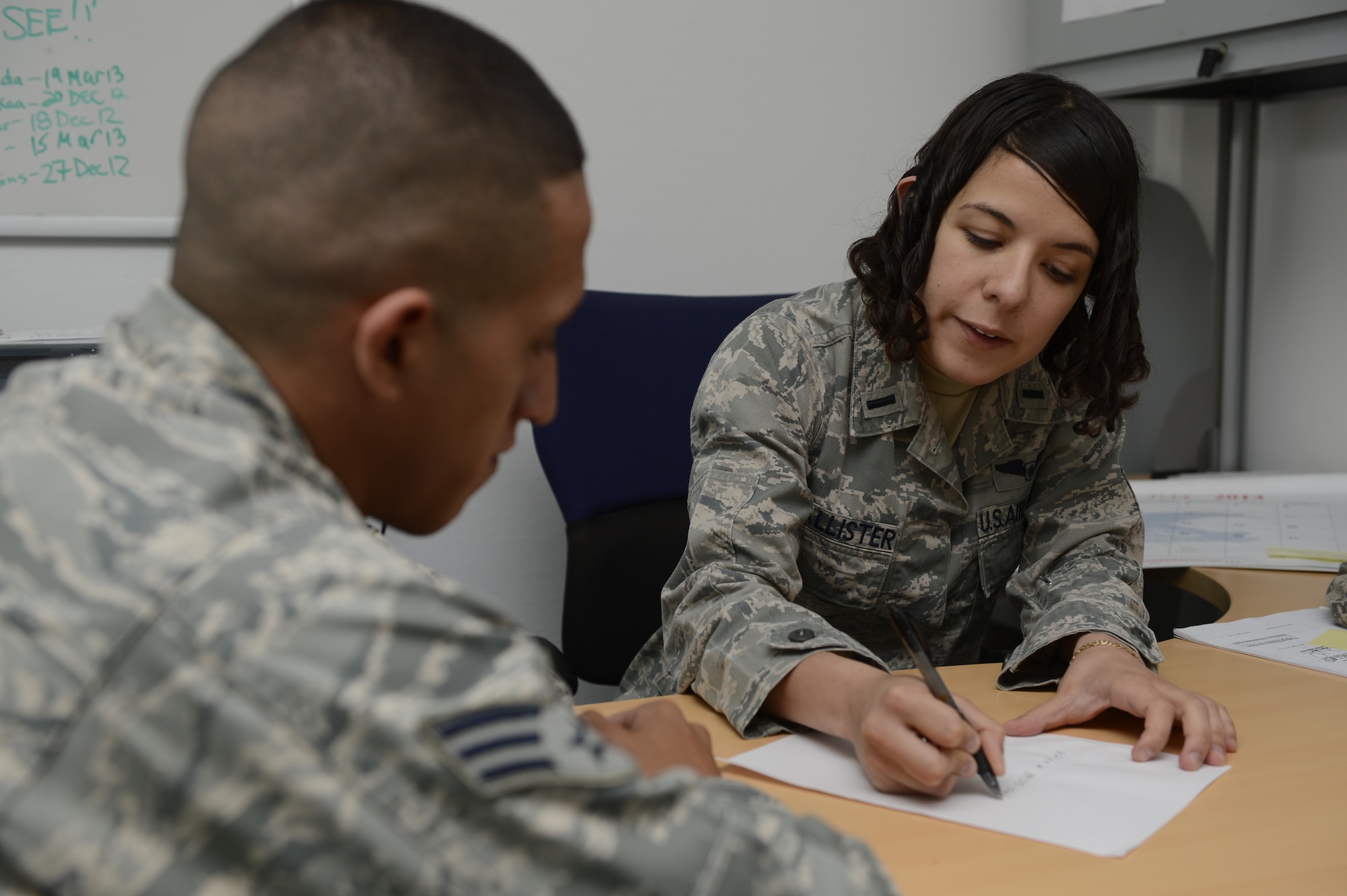 U.S. Air Force 1st Lt. Covey McAllister, 606th Air Control Squadron, deputy chief of current operations gives Senior Airman Adam Guerra, 606th ACS weapons director from Odessa, Texas, training on cleaning up radio communication format July 3, 2013. McAllister, who just returned from a deployment, passed on what she learned down range to other squadron members. (U.S. Air Force photo by Staff Sgt. Christopher Ruano/Released)