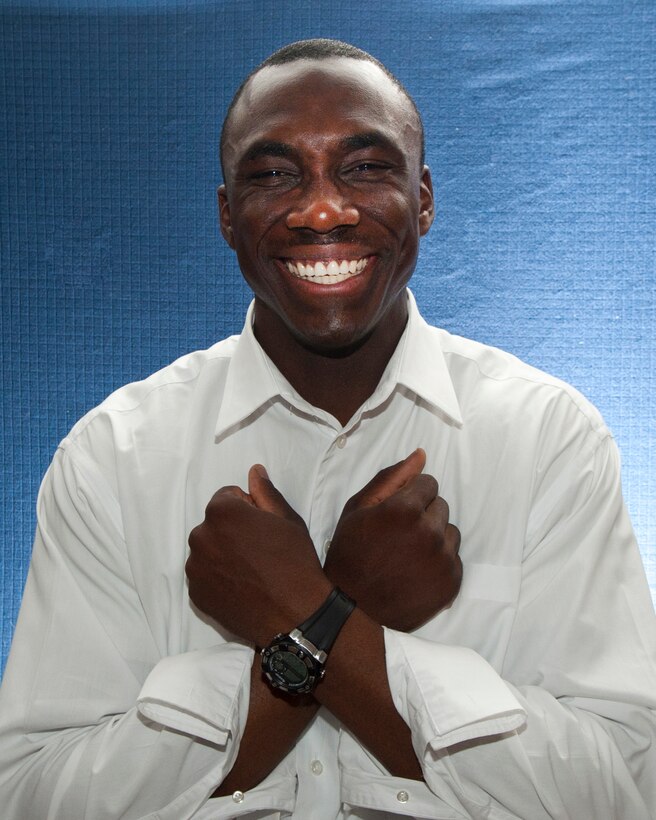 Staff Sgt. Stephen Small signs love while deployed at Transit Center at Manas, Kyrgyzstan, June 18, 2013. Small is the second youngest of seven children, all hearing children born to deaf parents. (U.S. Air Force photo/Staff Sgt. Robert Barnett)