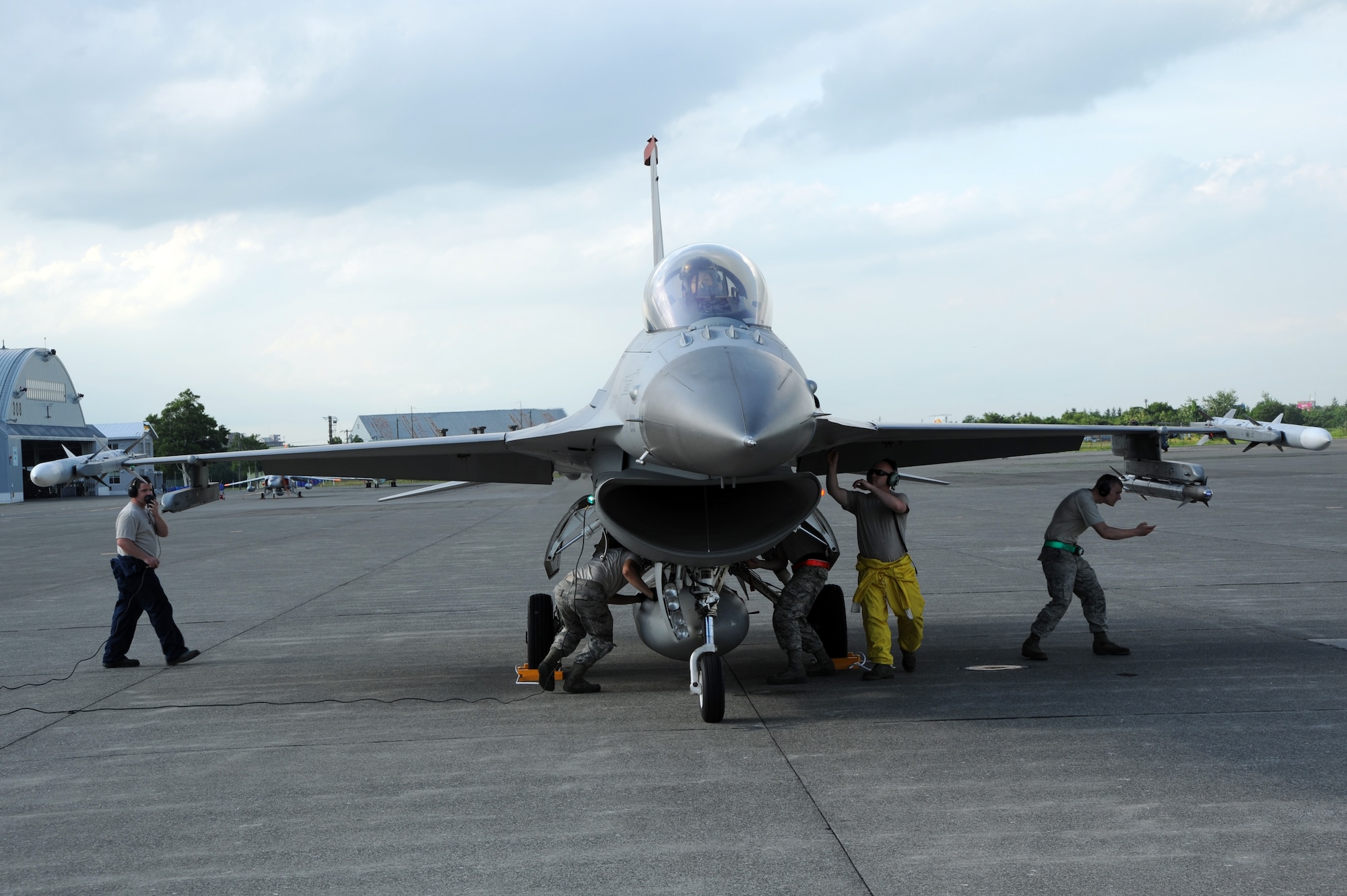 Maintainers from the 13th Aircraft Maintenance Unit perform post-flight checks and maintenance on a U.S. Air Force F-16 Fighting Falcon following a training mission flown over Chitose Air Base, Japan, July 9, 2013. The F-16 was piloted by 1st Lt. Michelle Hamland, 13th Fighter Squadron. U.S. pilots trained with plots from the Japan Air Self-Defense Force during a weeklong Aviation Training Relocation mission. (U.S. Air Force photo/Senior Airman Derek VanHorn)