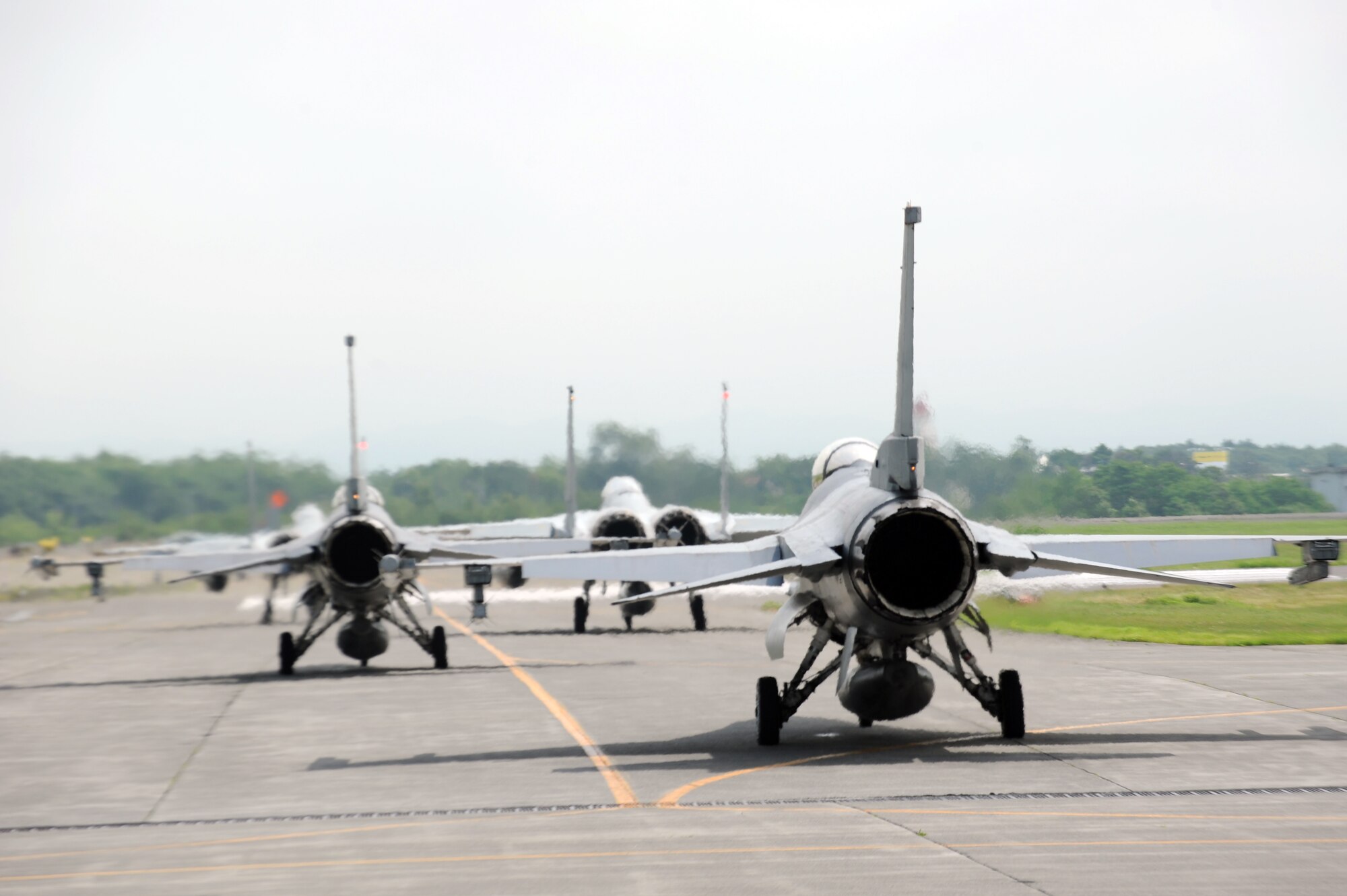 U.S. Air Force F-16 Fighting Falcons prepare for takeoff at Chitose Air Base, Japan, July 9, 2013. Nearly 100 Airmen, including 12 F-16 pilots, traveled to Chitose to participate in air-to-air simulated combat training with members of the Japan Air Self-Defense Force. (U.S. Air Force photo/Senior Airman Derek VanHorn)