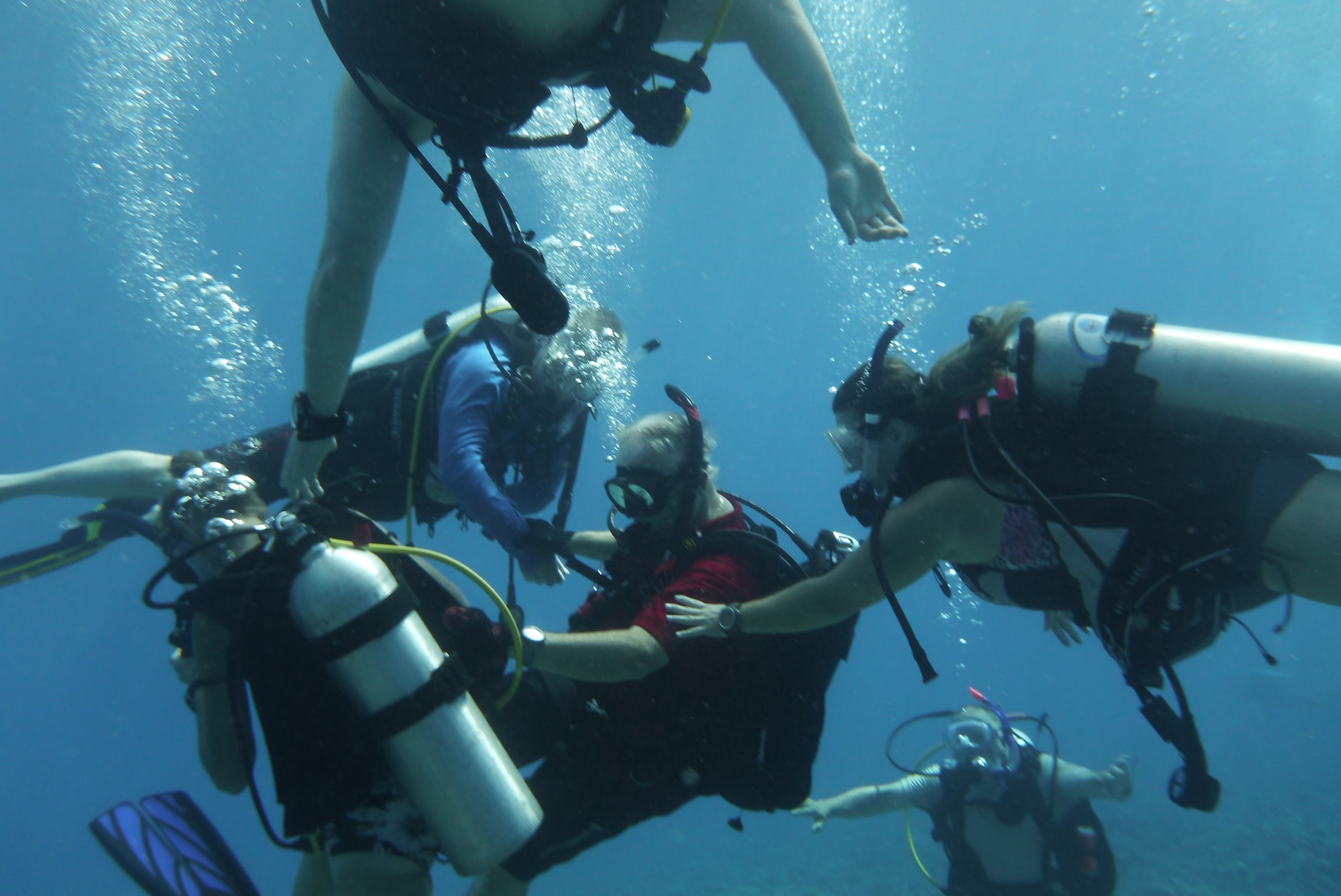 Bob Clark, 36th Force Support Squadron Andersen Family Dive Center instructor, teaches diving students during an advanced diving class in the Pacific Ocean, July 7, 2013. The Family Dive Center offers four main certification classes and 10 specialty courses. Anyone ages 8 and up can learn to dive. (U.S. Air Force photo by Staff Sgt. Veronica Montes/Released)