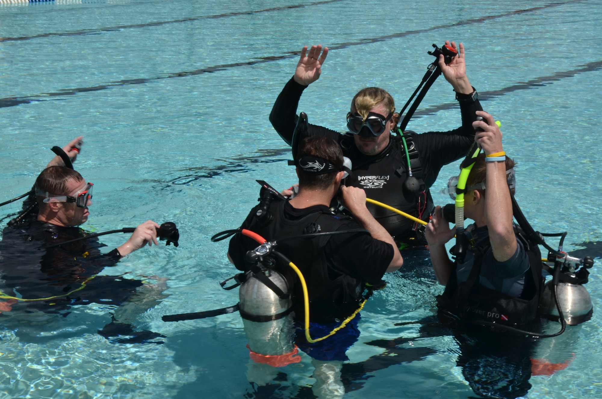 David Jenkins, 36th Force Support Squadron Andersen Family Dive Center instructor, teaches basic swimming kicks to students during an open-water class at the pool on Andersen Air Force Base, Guam, June 22, 2013. The Family Dive Center offers four main certification classes and 10 specialty courses. Anyone ages 8 and up can learn to dive. (U.S. Air Force photo by Staff Sgt. Veronica Montes/Released)