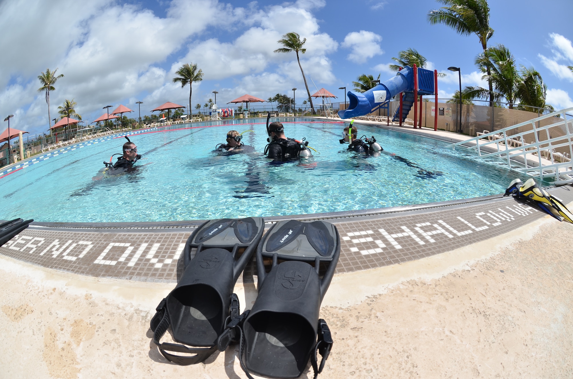 David Jenkins, 36th Force Support Squadron Andersen Family Dive Center instructor, teaches basic scuba skills during an open-water class at the pool on Andersen Air Force Base, Guam, June 22, 2013. Pool dives are an essential part of learning basic skills to prepare divers for the ocean. (U.S. Air Force photo by Staff Sgt. Veronica Montes/Released)