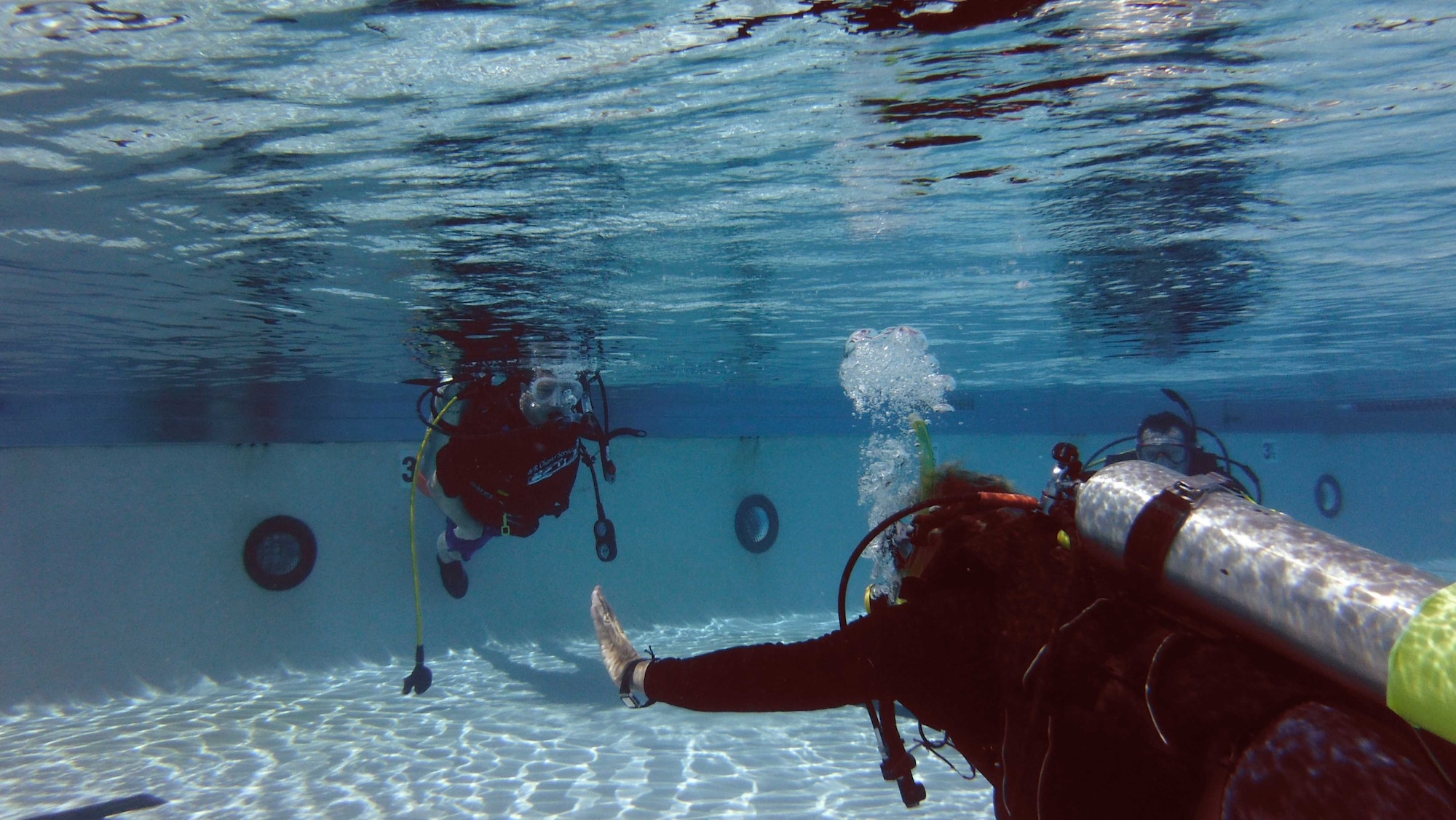 David Jenkins, 36th Force Support Squadron Andersen Family Dive Center instructor, teaches basic scuba skills in the pool at Andersen Air Force Base, Guam, June 22, 2013. The Family Dive Center offers four main certification classes and 10 specialty courses. Anyone ages 8 and up can learn to dive. (U.S. Air Force photo by Staff Sgt. Veronica Montes/Released)