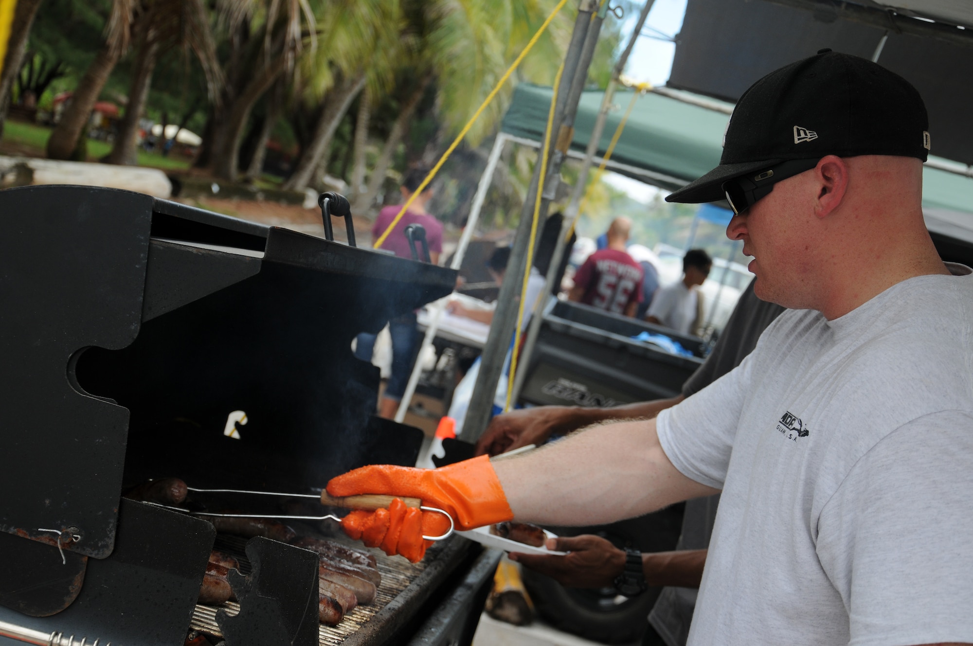 Staff Sgt. Phillip Cyb, 36th Security Forces Squadron confinement NCO in charge, grills bratwursts during the Freedom Fest July 5, 2013, on Andersen Air Force Base, Guam. More than 900 military members and their families attended the Freedom Fest at Tarague Beach in celebration of Independence Day. (U.S. Air Force photo by Staff Sgt. Melissa B. White/Released)