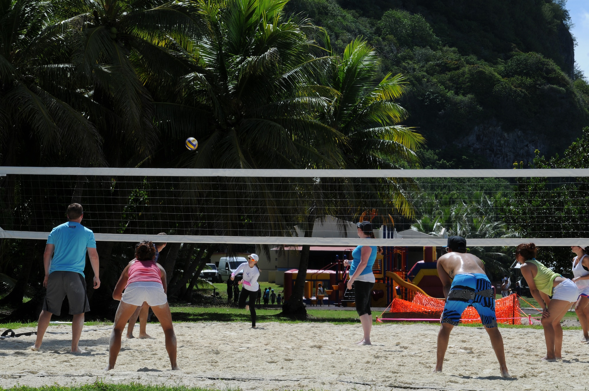 Members of Team Andersen play in a sand volleyball tournament during the Freedom Fest July 5, 2013, on Andersen Air Force Base, Guam. Sand volleyball, horseshoes and sandcastle contests were some of the events held during Freedom Fest at Tarague Beach in celebration of Independence Day. (U.S. Air Force photo by Staff Sgt. Melissa B. White/Released)
