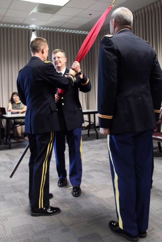 Colonel Richard Pannell, middle, accepts the flag from Southwestern Division commander Brig. Gen. Thomas W. Kula as Pannell assumes command of the Galveston District in ceremonies July 9.  