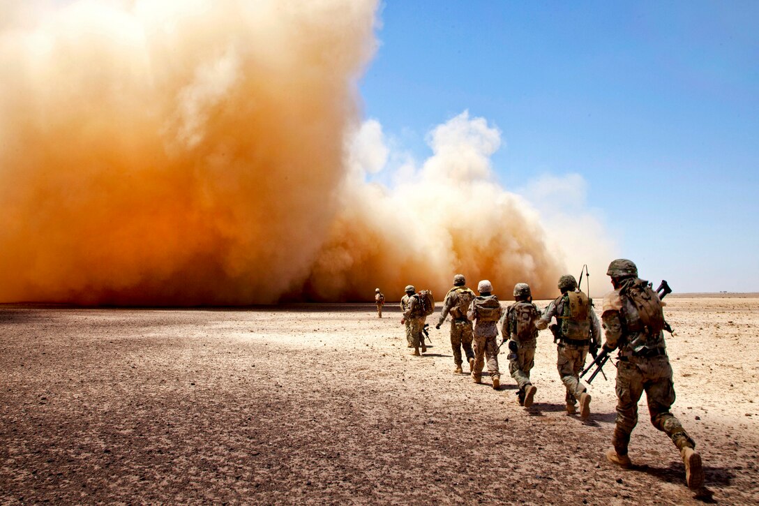 U.S. Marines and Georgian soldiers make their way to the extraction point during Operation Northern Lion II in Afghanistan's Helmand province, July 3, 2013. The Marines are assigned to Georgian Liaison Team 9. The Georgian soldiers led the operation to deter insurgents, establish a presence, and gather human intelligence in the area.