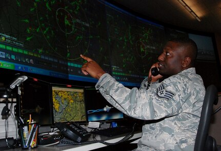 Staff Sgt. Jose Grimes, search and rescue duty officer with the Air Force Rescue Coordination Center at Tyndall Air Force Base, Fla., monitors the radar as he coordinates with another agency during a SAR mission. Sergeant Grimes played a critical role in locating a downed aircraft March 7 near the Canadian border in Maine and coordinating bi-national assets to rescue the aircrew member who survived.

