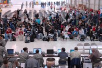 More than 140 military dependents prepare to process through the Denver International Airport aerial port of debarkation March 24. DIA, Seattle-Tacoma International Airport, Wash., and Travis Air Force Base, Calif., are receiving flights of military dependents who voluntarily left Japan as part of Operation Pacific Passage following the earthquake and tsunami that struck Japan March 11. 


