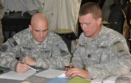 Maj. Darrell Watkins, 1st Squadron, 13th Cavalry Regiment Operations Officer, left, and Capt. Gilbert Redford, Chosin Company commander, coordinate a JTF North mission executed in support of the U.S. Border Patrol – Tucson Sector. During the U.S. Border Patrol – Tucson Sector support mission, the 1st Squadron, 13th Cavalry Regiment Soldiers served as the ‘eyes and ears’ of the agents that patrol the Arizona – Sonora, Mexico border area. 

