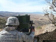 Spc. Arturo Saucedo, cavalry scout, Apache Troop, 1st Squadron, 13th Cavalry, surveys the Arizona – Mexico border for suspected illegal activities using a Long Range Scout Surveillance System (LRAS). The ‘Warhorse’ Cavalry Scouts reported their observations to the U.S. Border Patrol agents in the field. 


