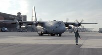 A crew chief with the 302nd Airlift Wing marshals a C-130 for take-off at Peterson Air Force Base, Colo., April 16. Aircraft and crews from the 302nd AW have been assigned to assist the Mexican government in fighting wildland fires in Northern Mexico. 

