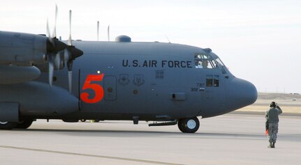 A crew chief with the 302nd Airlift Wing marshals a Modular Airborne Firefighting System-equipped C-130 in preparation for take-off at Peterson Air Force Base, Colo., April 16. Aircraft and crews from the 302nd AW have been assigned to assist the Mexican government in fighting wildland fires in Northern Mexico. The MAFFS, which is owned and maintained by the U.S. Forest Service, is a pressurized self-contained firefighting system designed for installation in C-130 aircraft without structural modifications to the aircraft. The system is designed to air-drop fire-retardant chemicals onto wildfires. 

