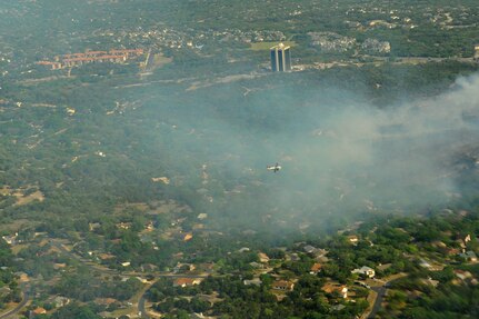 A lead plane from the U.S.D.A. Forest Service guides a C-130, from the 302nd Airlift Wing, Peterson Air Force Base, Colo., toward a wildfire west of Austin, Texas, April 17. U.S. Northern Command has deployed six C-130 aircraft equipped with the U.S.D.A. Forest Service’s Modular Airborne Fire Fighting System to support the fight against ongoing wildfires in the area. 


