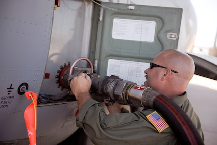 U.S. Air Force Master Sgt. Chuck Watkins, 115th Airlift Squadron, California Air National Guard, connects a fuel hose to a C-130J Hercules while preparing the aircraft for firefighting operations at Dyess Air Force Base, Texas, April 18, 2011. The C-130 is equipped with the Modular Airborne Firefighting System(MAFFS) which is capable of dispensing 3,000 gallons of water or fire retardant in under 5 seconds. 

