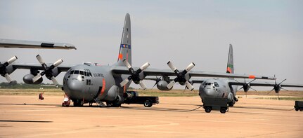 Airmen from California Air National Guard's 146th Airlift Wing, North Carolina Air National Guard's 145th Airlift Wing and Wyoming Air National Guard's 153rd Airlift Wing gather at Dyess Air Force Base, Texas to prepare for wildfire fighting operations, April 18, 2011. The Airmen maintain and operate the Modular Airborne Firefighting System(MAFFS) housed aboard a C-130 Hercules which is capable of dispensing 3,000 gallons of water or fire retardant in under 5 seconds. The wildfires have spread across various parts of Texas and have burned more than 1,000 square miles of land. 

