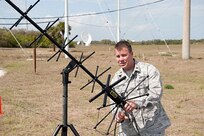 Maj. Larry Skipper, 601st Air and Space Operations Center configuration manager at Tyndall AFB, Fla., adjusts a Joint-Based Expeditionary Connectivity Center antenna at Cape Canaveral AFS, Fla., before the final launch of Space Shuttle Discovery Feb. 24, 2011. JBECC provides a comprehensive air picture to the entire launch team. 

