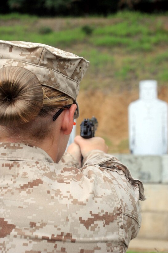 Sgt. Autum Bickham, non-commissioned officer-in-charge, supply, Headquarters and Service Bn., fires at a target during an annual pistol qualification aboard Marine Corps Base Quantico on July 10, 2013. Pistol qualifications are transitioning to a new program including drawing from a holster. 