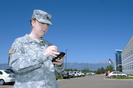 Army National Guard Sgt. Stephanie Peavy, 244th Army Liaison Team from Chicago, works with a "Life Ring" cell phone being demonstrated at the Coalition Warrior Interoperability Demonstration in Colorado Springs June 15. CWID is part exercise, part vendor demonstration, where companies offering new technologies can demonstrate their products in a realistic environment. The Life Ring is a cell phone system that combines a GPS and satellite communications, allowing continuous communication and tracking through a G3 network cell phone regardless of conditions on the ground. This allows first responders in a disaster situation to maintain contact with their organization leadership even if cell towers in the area have been destroyed. 

