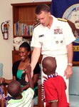 A resident of the Grand Bahama Children’s Home greets Adm. James A. Winnefeld, Jr., NORAD and USNORTHCOM commander, on arrival to the home June 30. The commander visited the home with U.S. Ambassador to The Bahamas Nicole A. Avant to present $2,500 worth of clothing, footwear, bedding, games and art supplies to the home on behalf of USNORTHCOM’s Humanitarian Assistance Program. 

