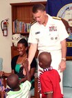 A resident of the Grand Bahama Children’s Home greets Adm. James A. Winnefeld, Jr., NORAD and USNORTHCOM commander, on arrival to the home June 30. The commander visited the home with U.S. Ambassador to The Bahamas Nicole A. Avant to present $2,500 worth of clothing, footwear, bedding, games and art supplies to the home on behalf of USNORTHCOM’s Humanitarian Assistance Program. 

